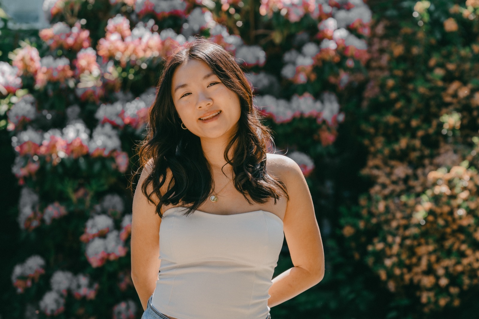 Cat Cheng smiling with flowers behind her