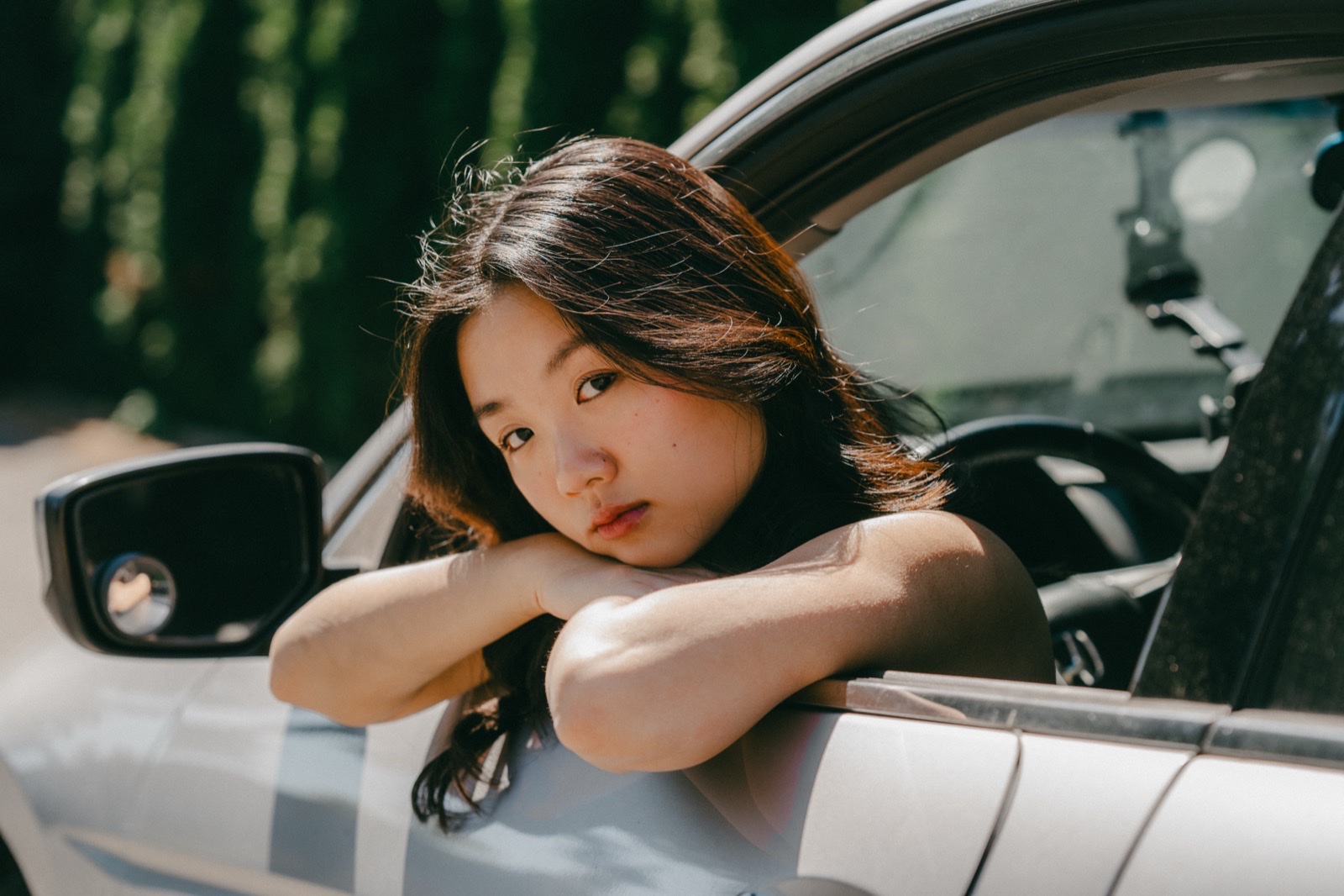 Cat Cheng sticking her head out of a car and resting on her forearms
