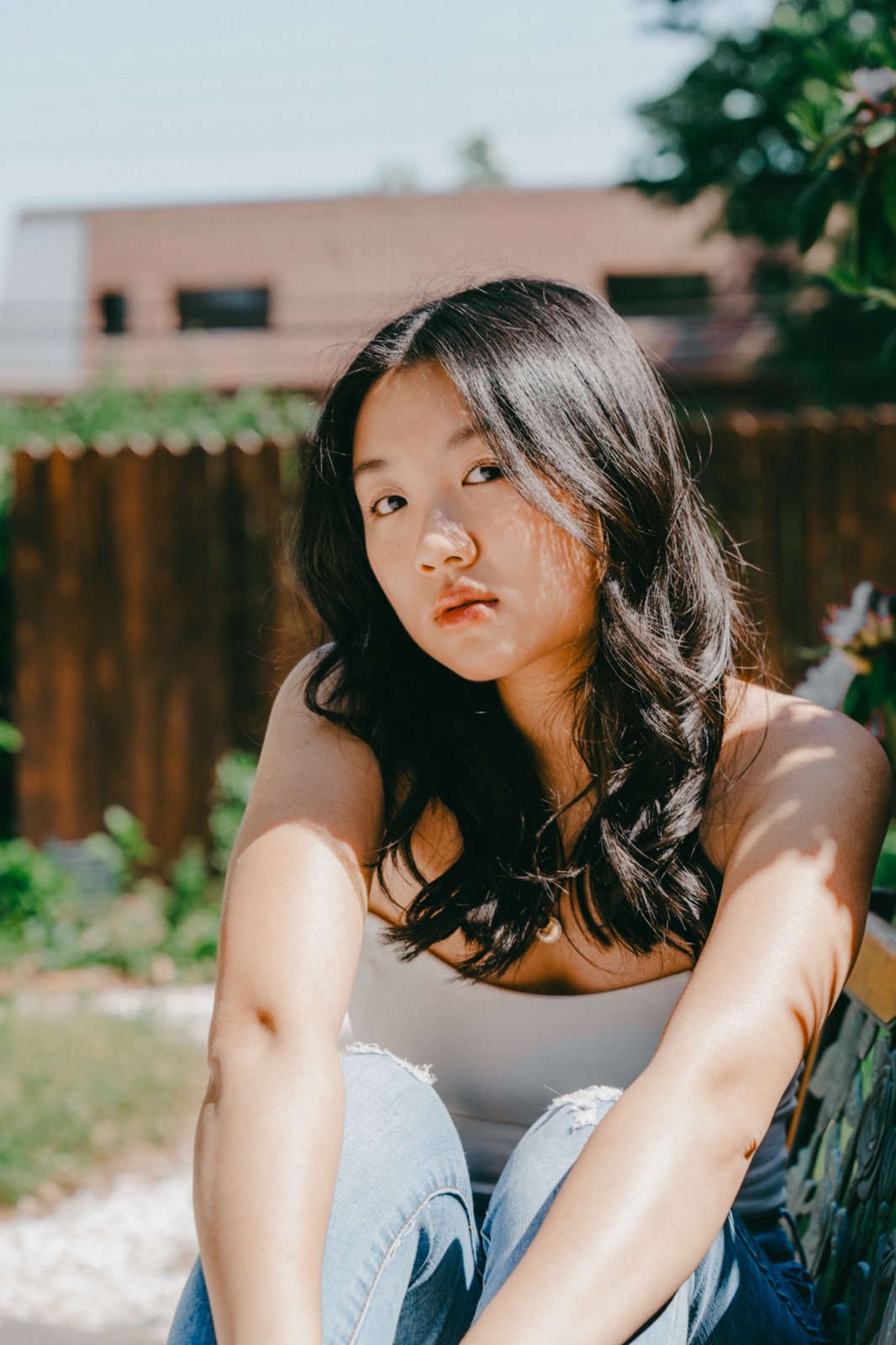 Cat Cheng sitting in a garden
